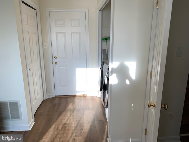 clothes washing area featuring dark hardwood / wood-style flooring and independent washer and dryer