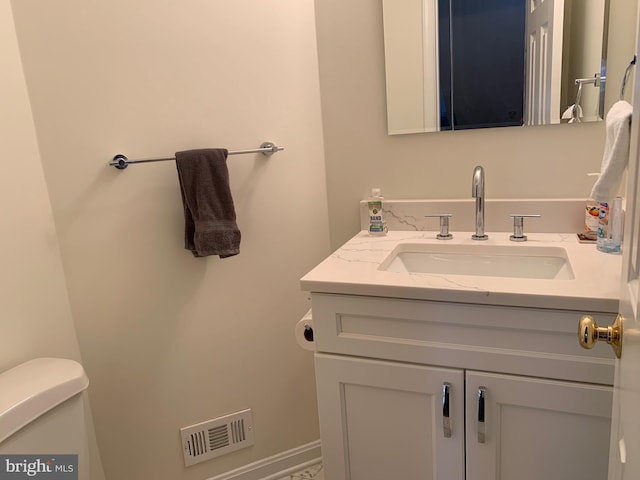 bathroom featuring vanity and toilet