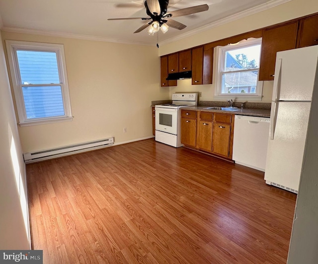 kitchen featuring ornamental molding, white appliances, baseboard heating, sink, and wood-type flooring