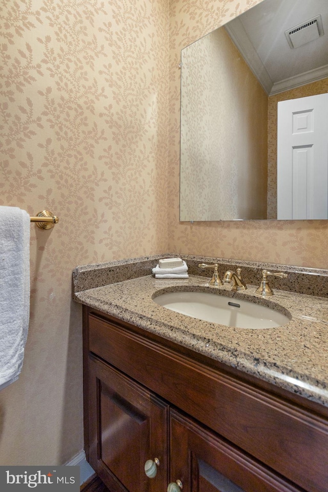 bathroom featuring vanity and ornamental molding