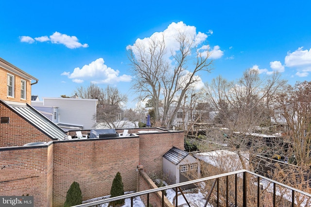 view of snow covered back of property