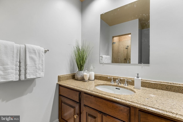 bathroom featuring walk in shower and vanity