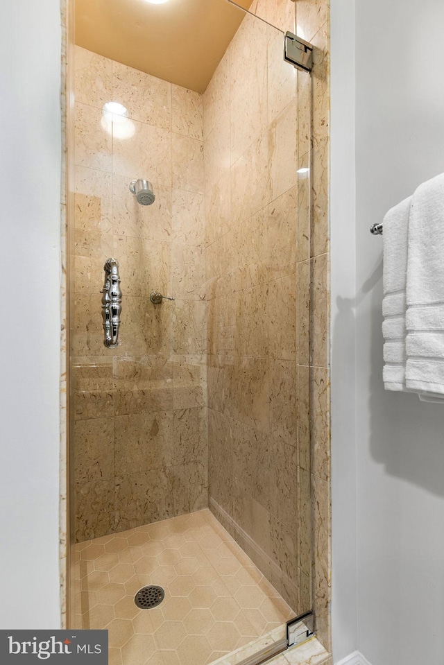 bathroom with a shower with door