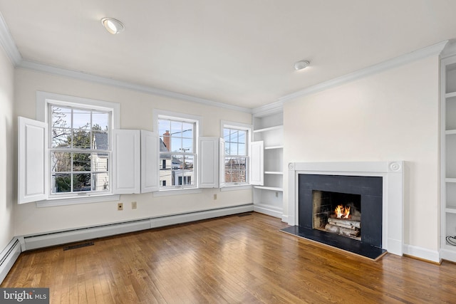 unfurnished living room with hardwood / wood-style flooring, a healthy amount of sunlight, and a baseboard heating unit