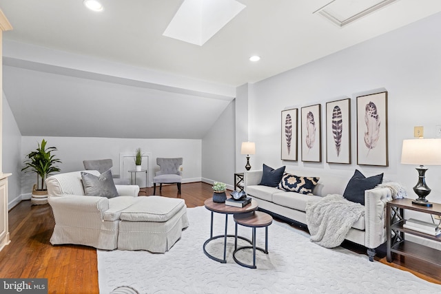 living room with vaulted ceiling with skylight and wood-type flooring