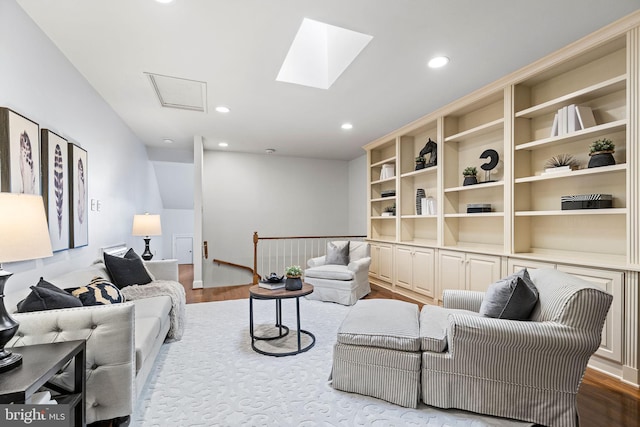 living room featuring a skylight and light hardwood / wood-style floors