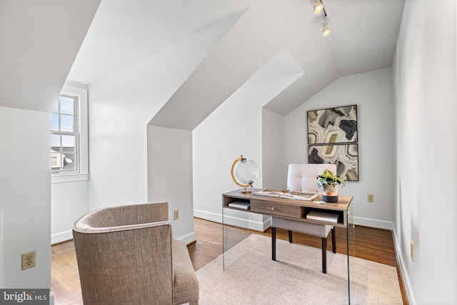 home office featuring vaulted ceiling and light hardwood / wood-style floors