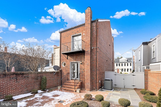 back of house featuring central AC unit and a patio