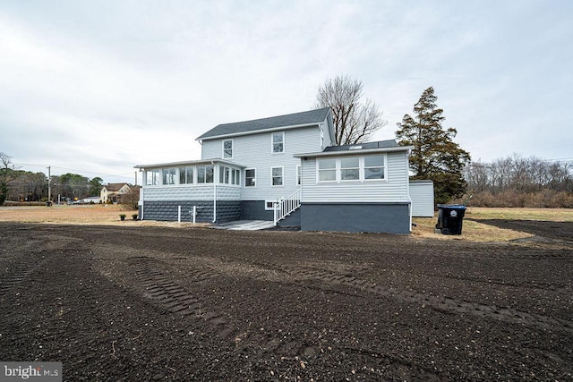 rear view of house with a sunroom