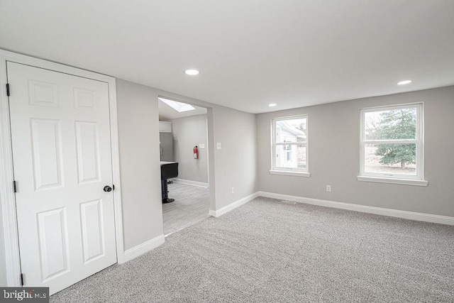 unfurnished room with light carpet