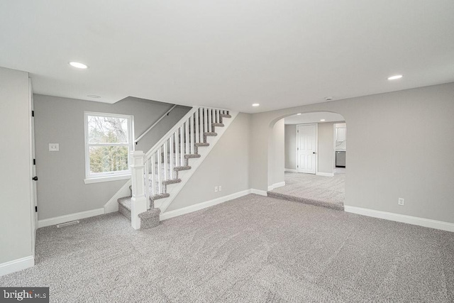 unfurnished living room featuring light colored carpet