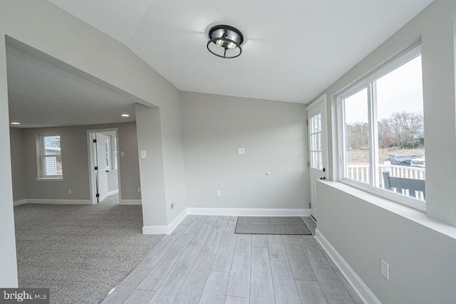 empty room featuring light hardwood / wood-style floors and lofted ceiling