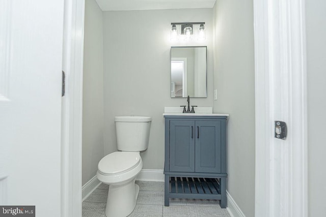 bathroom with tile patterned flooring, vanity, and toilet