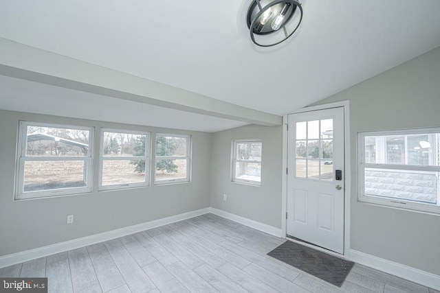 entryway featuring light hardwood / wood-style flooring and vaulted ceiling