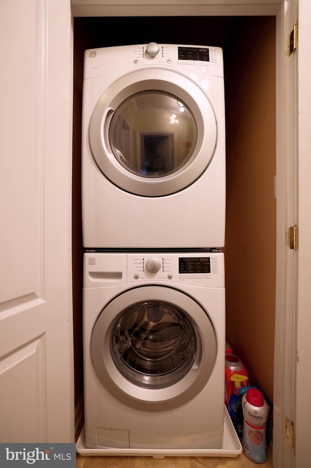 laundry area featuring stacked washer / drying machine