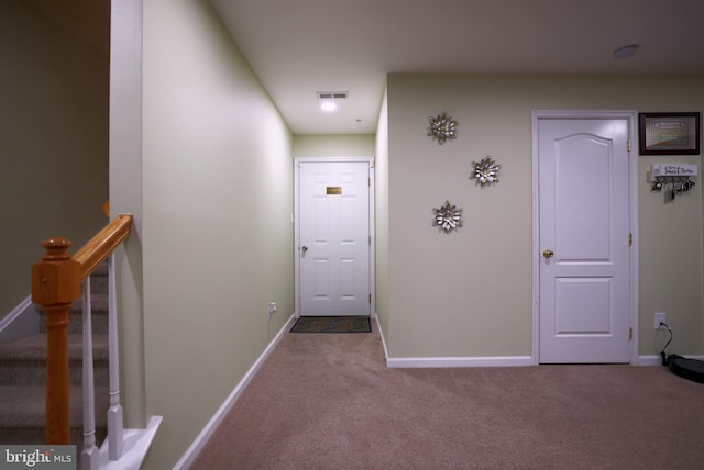 doorway featuring light colored carpet