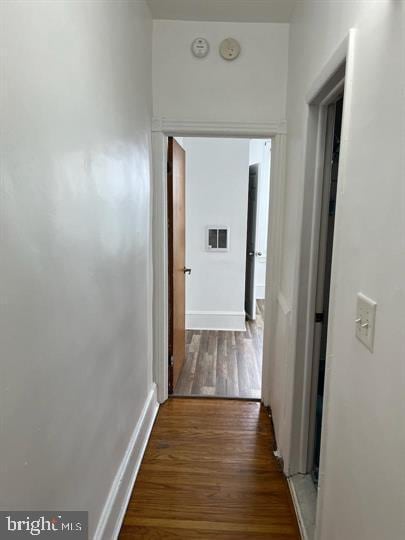 corridor with dark wood-type flooring