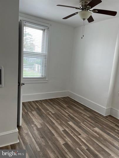 empty room featuring ceiling fan and dark wood-type flooring