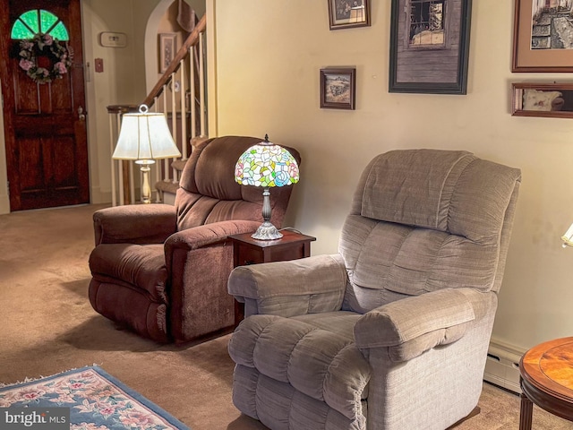 living area featuring light carpet and a baseboard radiator