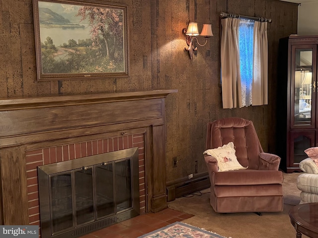 living area with wooden walls and a brick fireplace