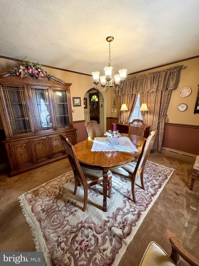 carpeted dining room with a textured ceiling and an inviting chandelier