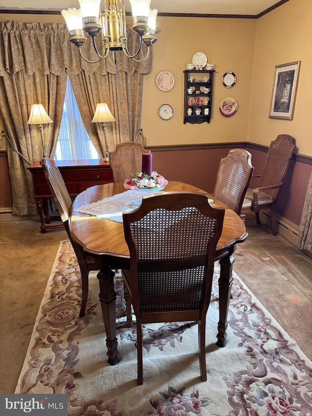 dining room with carpet, crown molding, and a notable chandelier