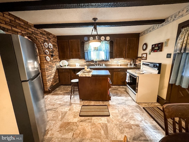 kitchen with beam ceiling, hanging light fixtures, white electric range oven, stainless steel fridge, and a kitchen island