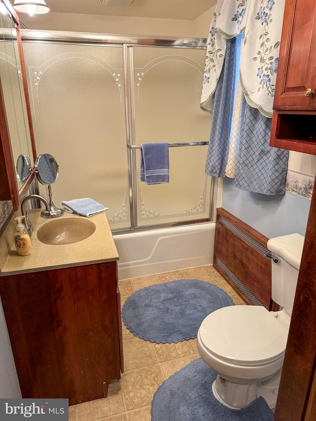 full bathroom with tile patterned flooring, vanity, toilet, and enclosed tub / shower combo