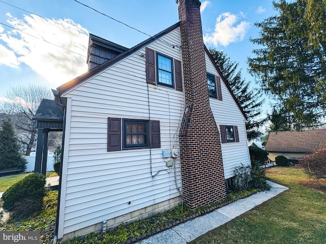 view of home's exterior with a yard