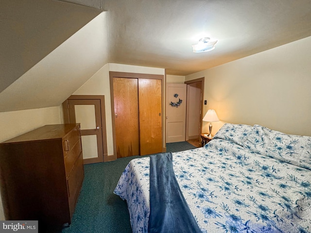 carpeted bedroom with a closet and lofted ceiling