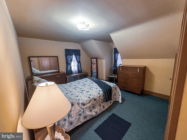 carpeted bedroom with radiator heating unit and vaulted ceiling