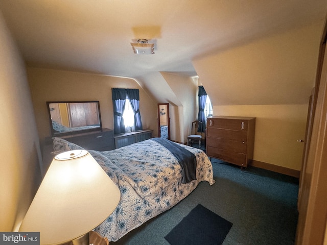 bedroom with carpet floors and vaulted ceiling