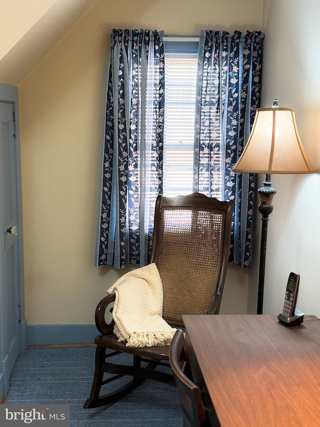 living area with carpet flooring and vaulted ceiling