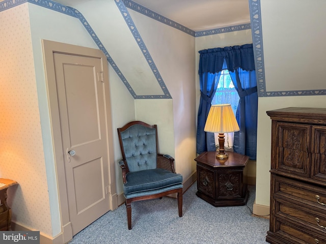 sitting room featuring carpet and vaulted ceiling