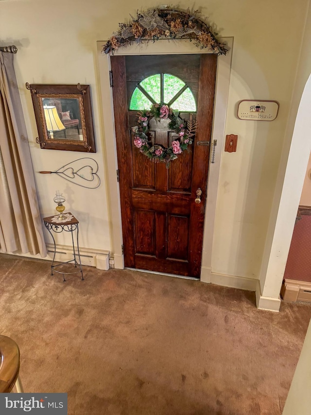 carpeted entryway with a baseboard radiator