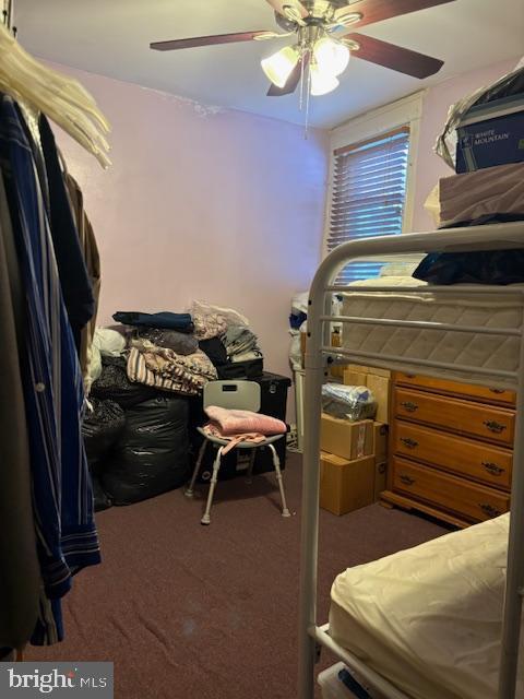 bedroom with dark colored carpet and ceiling fan