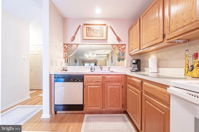 kitchen featuring a chandelier, dishwasher, light hardwood / wood-style floors, and sink