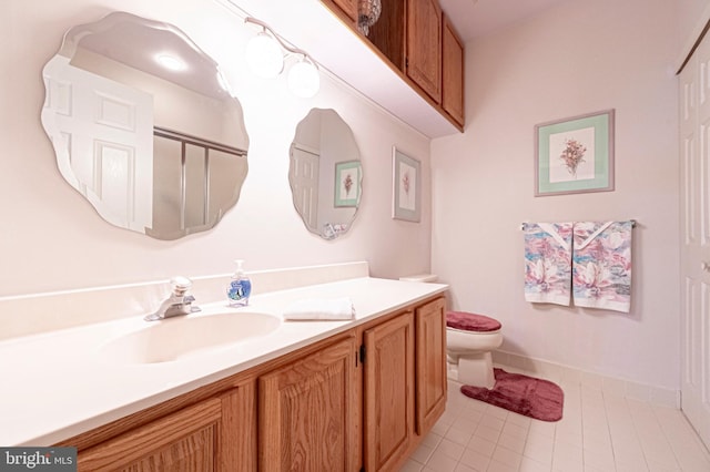 bathroom with tile patterned flooring, vanity, and toilet