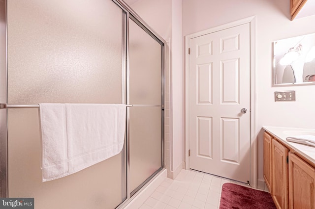 bathroom with tile patterned flooring, vanity, and an enclosed shower