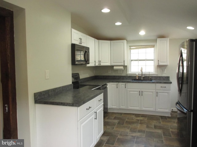 kitchen with sink, white cabinets, and black appliances