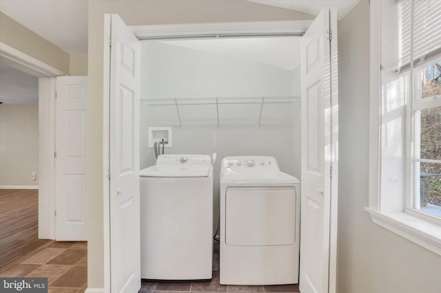 laundry room featuring dark tile patterned flooring and washing machine and clothes dryer