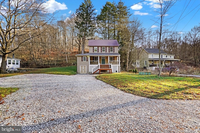 view of front of home featuring covered porch and a front yard