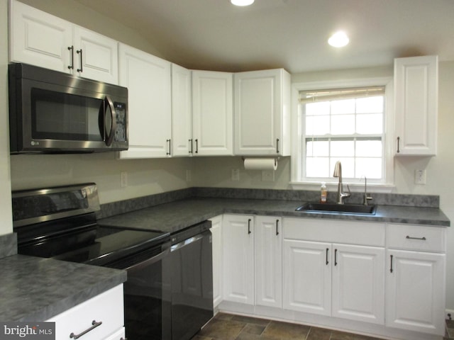 kitchen with sink, white cabinets, and black appliances