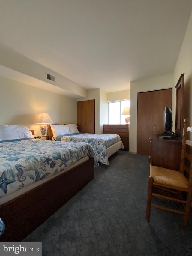 bedroom with visible vents and carpet floors