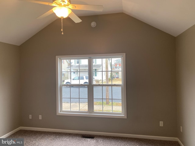 unfurnished room featuring ceiling fan, carpet, and lofted ceiling