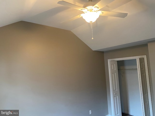 unfurnished bedroom featuring a closet, vaulted ceiling, and ceiling fan