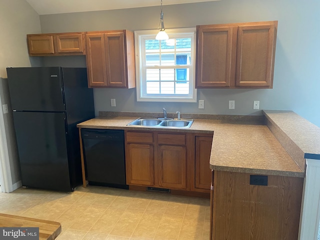 kitchen with hanging light fixtures, sink, and black appliances