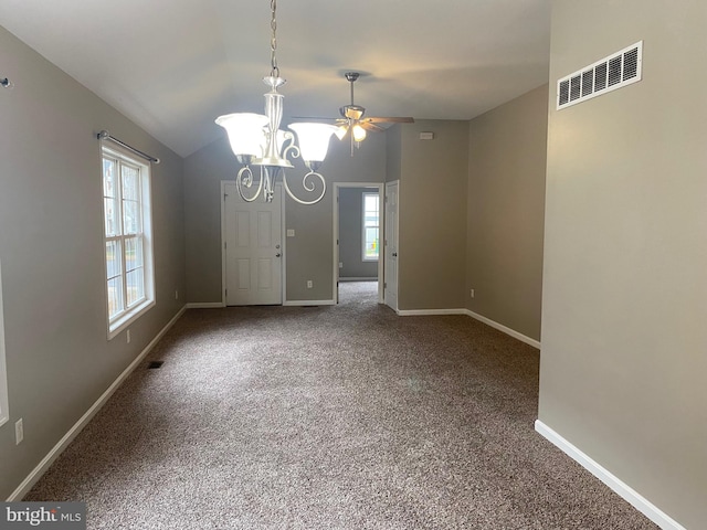 spare room with plenty of natural light, carpet floors, ceiling fan with notable chandelier, and lofted ceiling