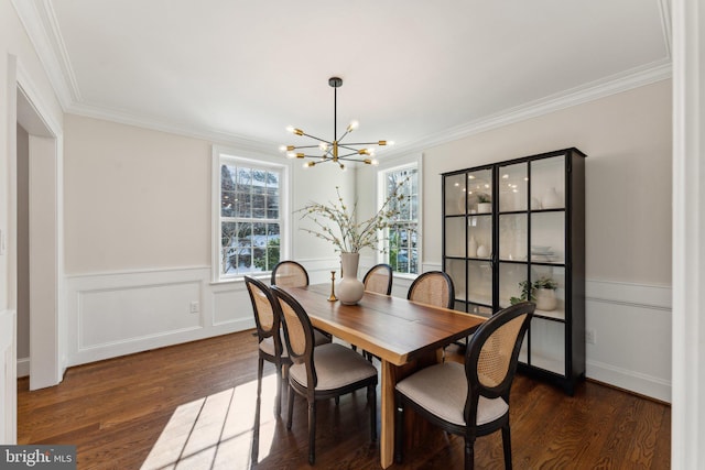 dining area with dark hardwood / wood-style floors, crown molding, and a chandelier