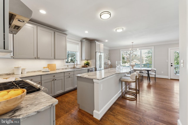 kitchen with pendant lighting, gray cabinetry, sink, appliances with stainless steel finishes, and a kitchen island